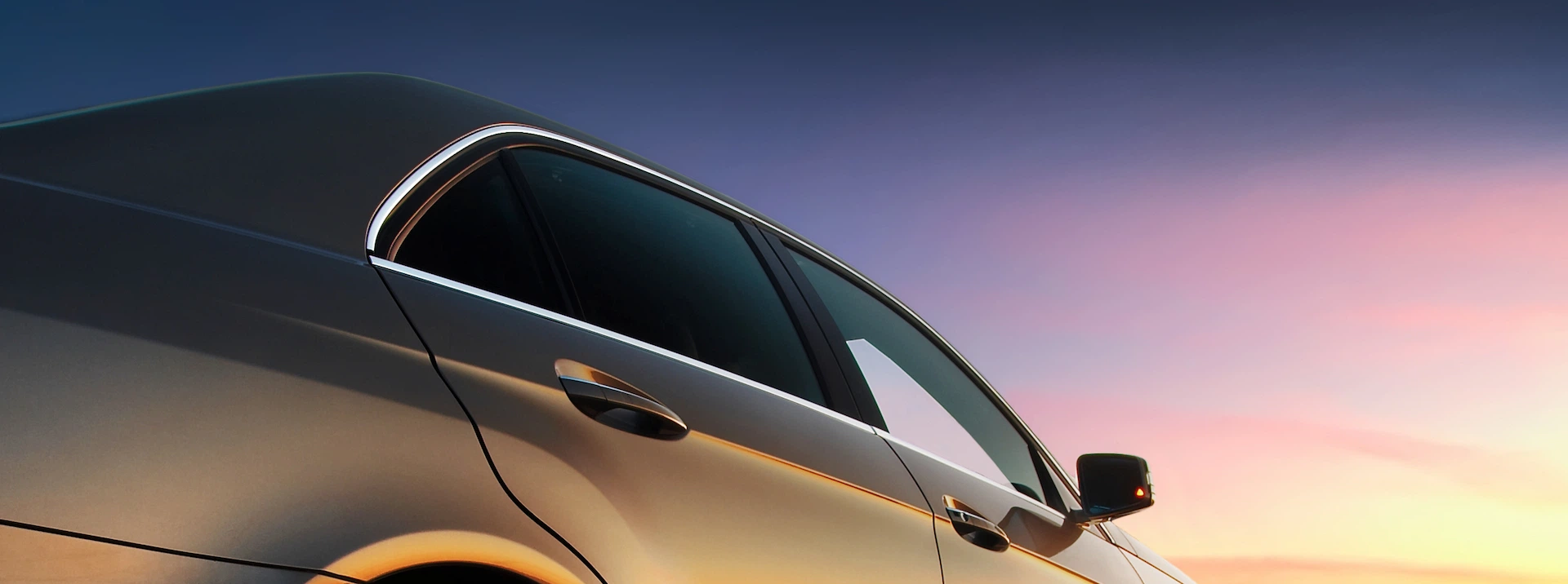Car with heat-shielding for optimal EV efficiency and glass that illuminates at sunset.
